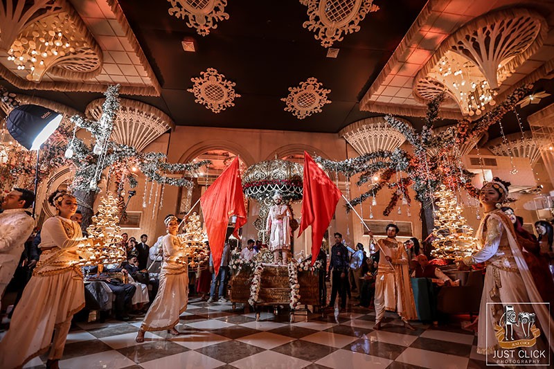 Wedding venue decorated with colourful drapes and lights