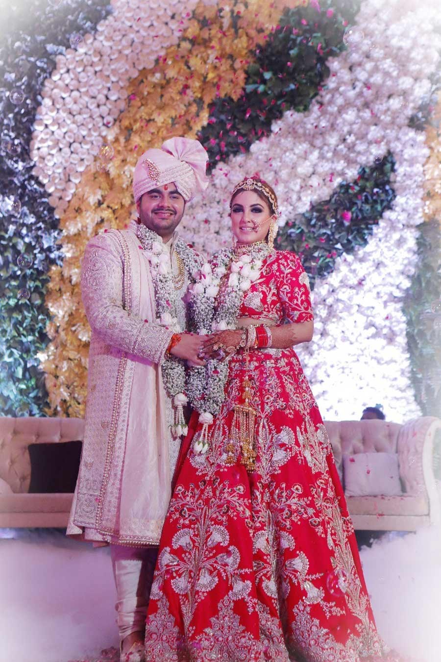 Saurabh and Gargi amid floral decor and sunlight at their wedding