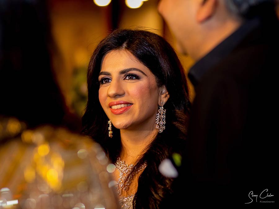 Bride posing solo in a sparkling gold and pink embellished outfit