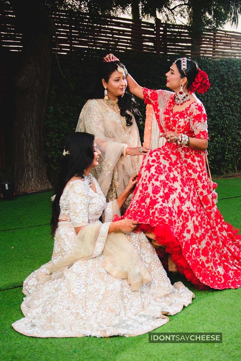 Close-up of bride and groom together in red attire