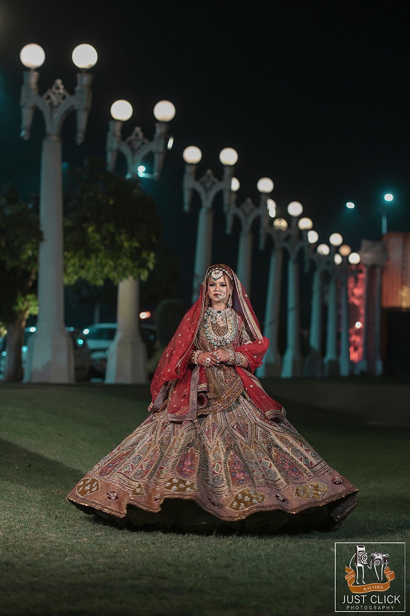 Bride walking outdoors in a red bridal outfit