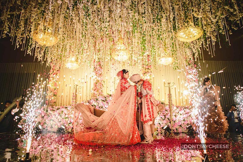 Bride and groom standing together on a decorated stage
