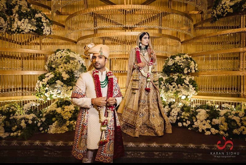 Bride and groom standing together in a warmly lit venue