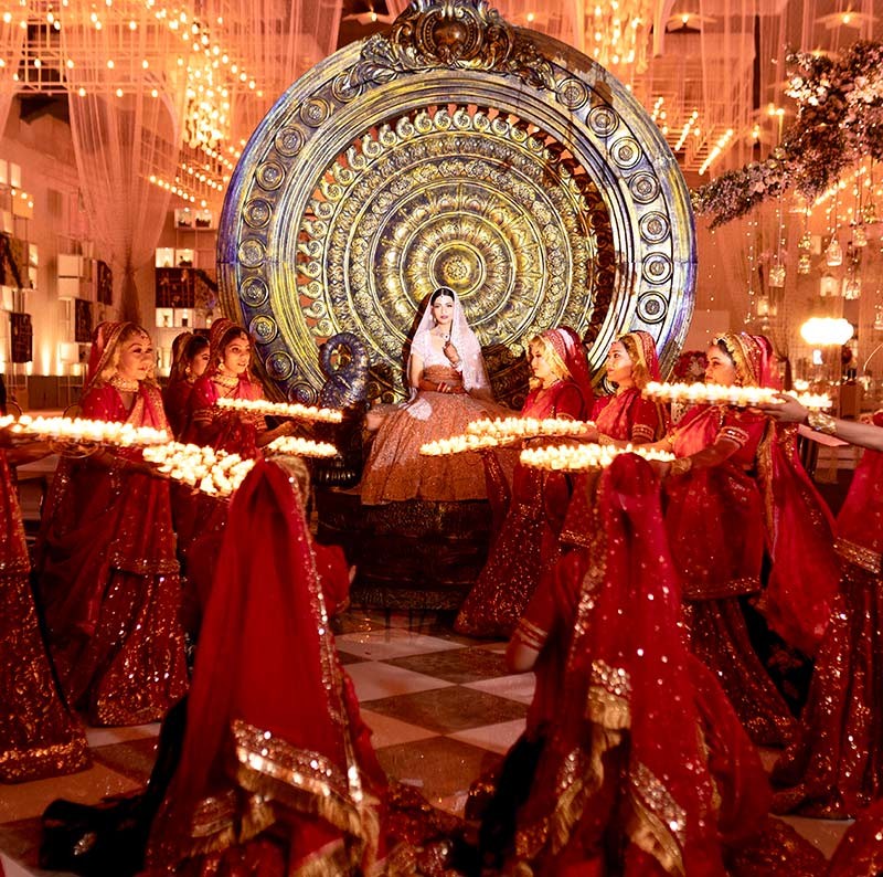Bride and groom posing closely together with red decor