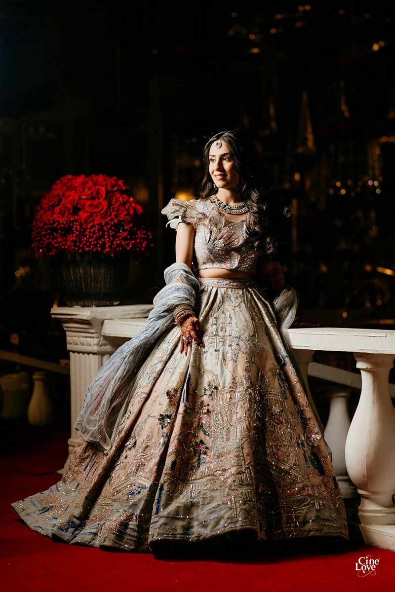 Bride showing the full length of her gold embellished gown