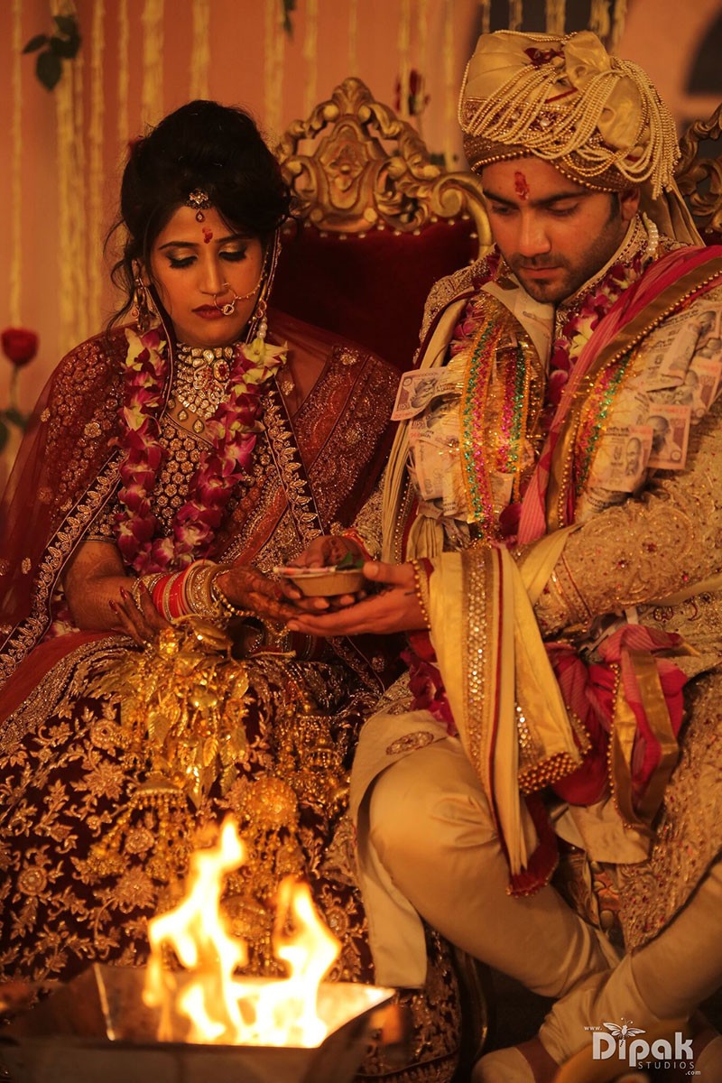 Rachit and Garima during a warmly lit wedding ceremony