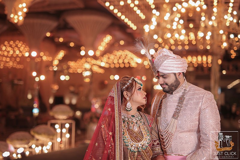 Bride and groom standing together on a decorated stage