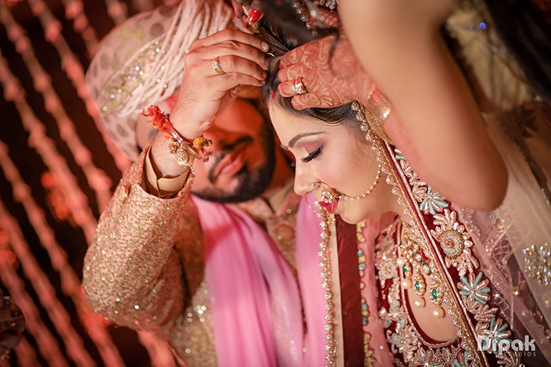 Bride Anjali's hands adorned with intricate mehendi henna