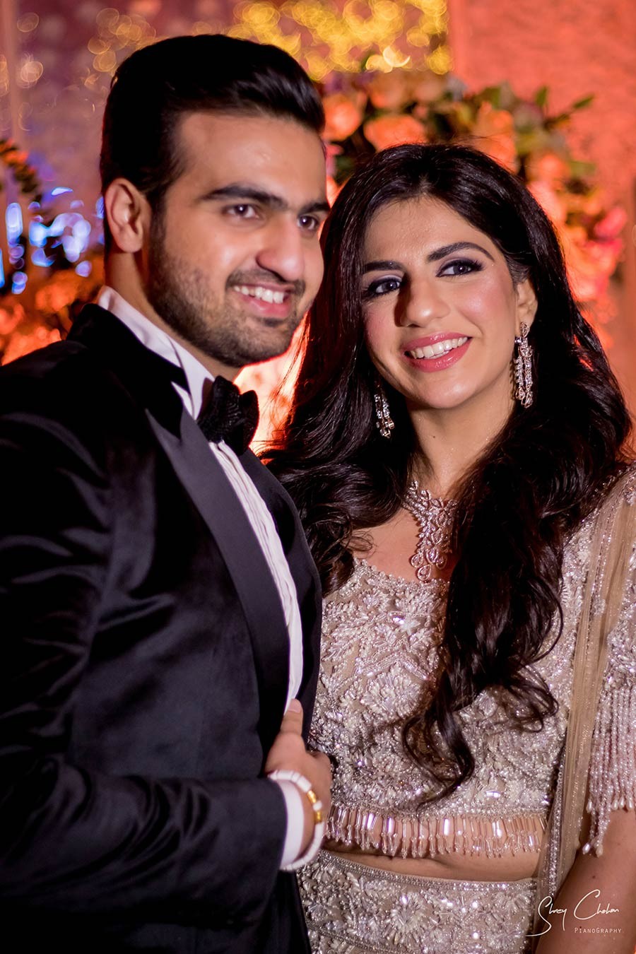 Close-up portrait of bride and groom smiling in formal wedding attire