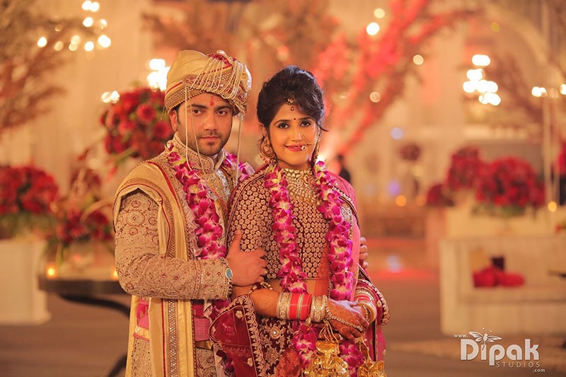 Bride Garima in traditional red bridal attire