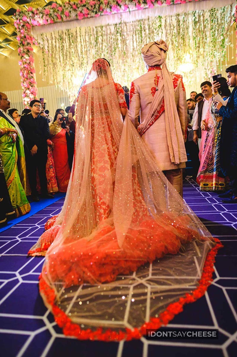 Bride showing the full length of her orange and red bridal outfit