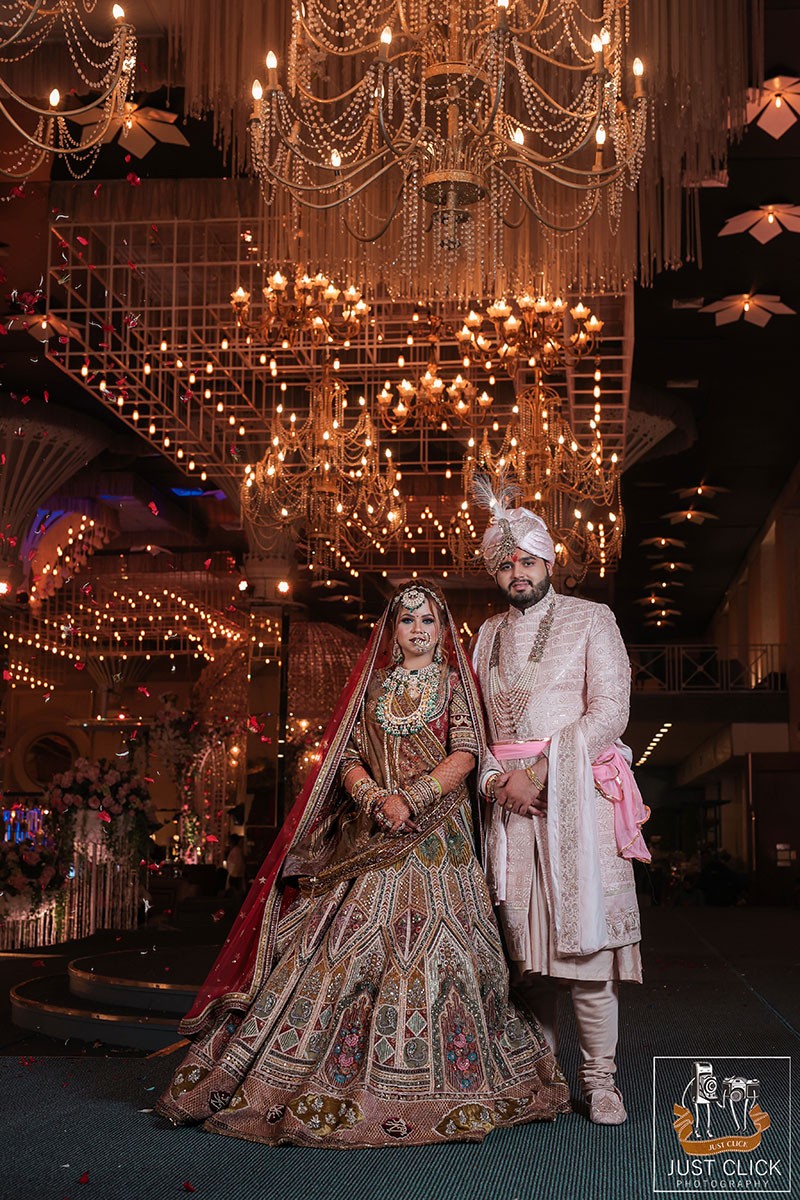 Bride posing solo under an ornate chandelier