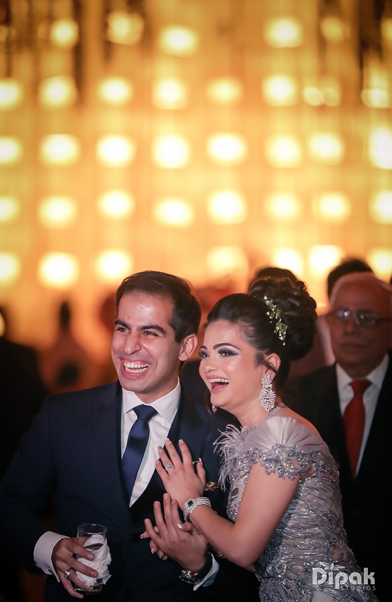 Ria and Manyu seated together against a backdrop of glowing bokeh lights