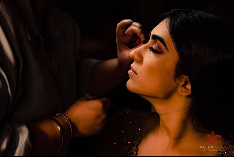 Close-up candid photo of the bride adjusting her earring