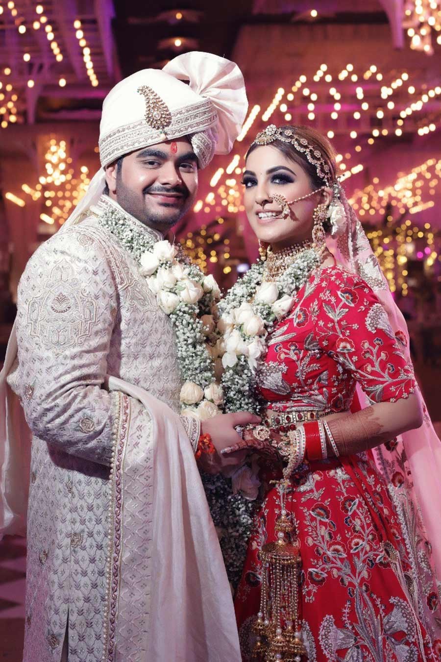 Saurabh and Gargi in cream and red traditional attire at their wedding