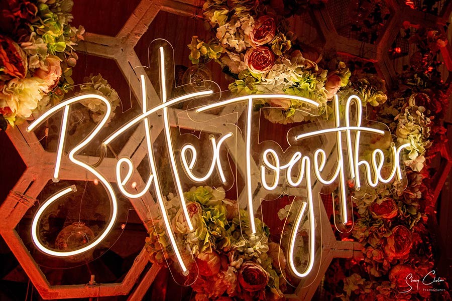 Glowing neon 'Better Together' sign at Vrinda and Mohit's wedding celebration
