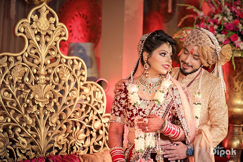 Bride Anjali in ornate gold bridal attire amid festive decor