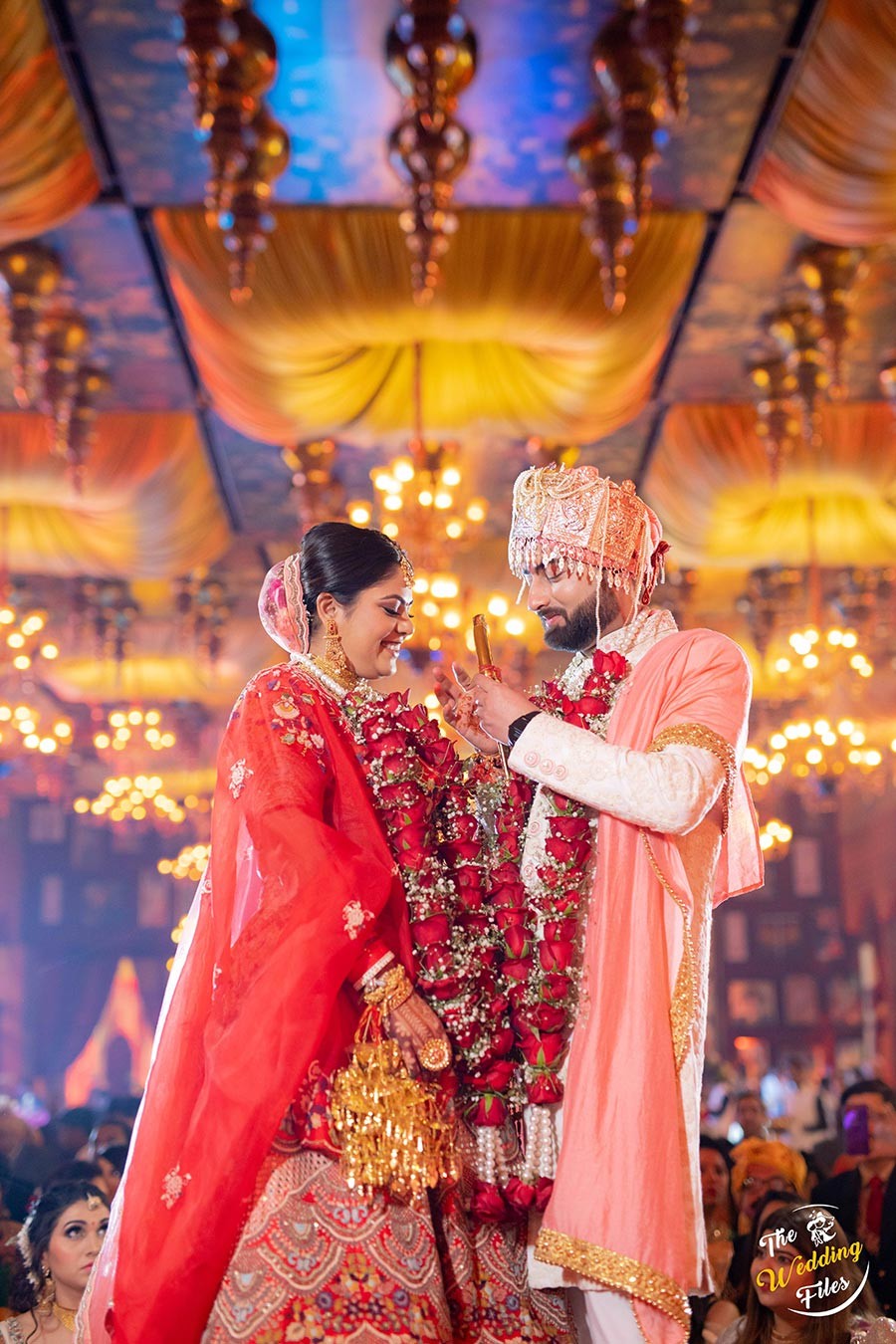 Sanya and Anish performing a wedding ritual in traditional attire