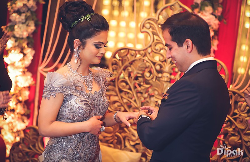 Ria and Manyu at their traditional wedding ceremony surrounded by warm decor