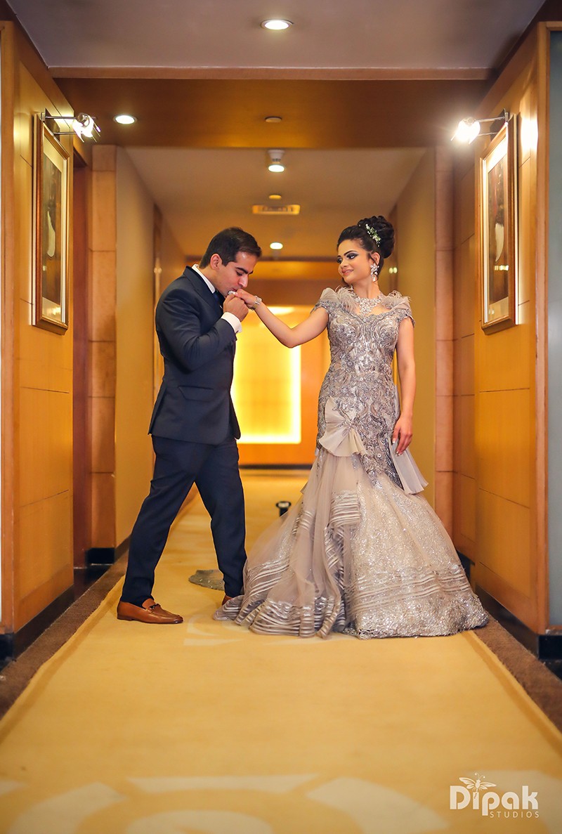 Ria and Manyu walking together in traditional Indian wedding attire