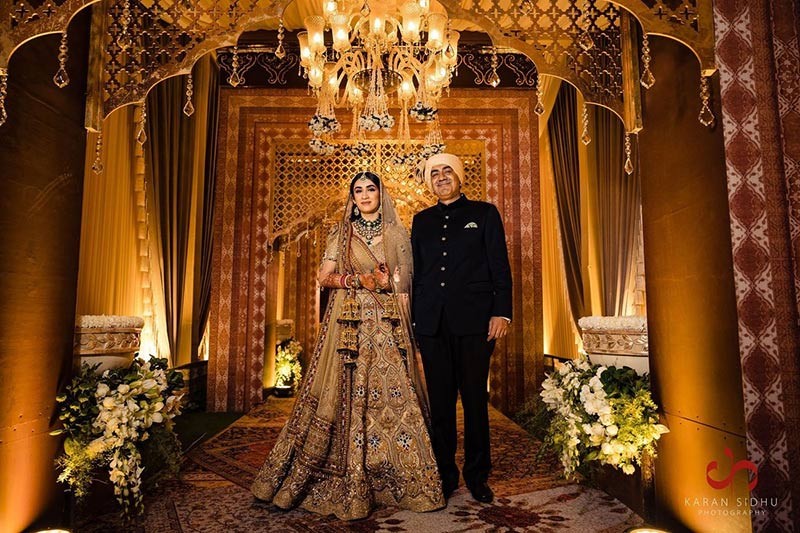 Bride showing the full length of her embellished bridal gown