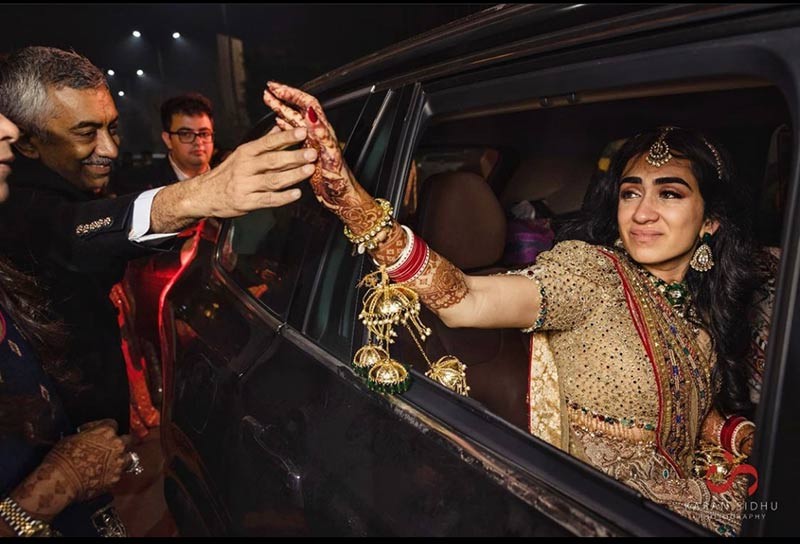 Person raising hand in a celebratory blessing gesture at the wedding