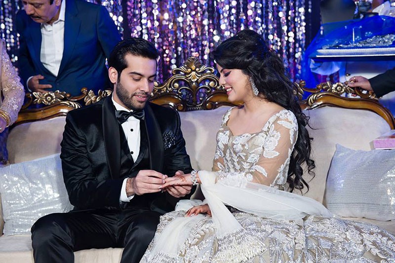 Neha and Pawan seated at their elegant wedding reception