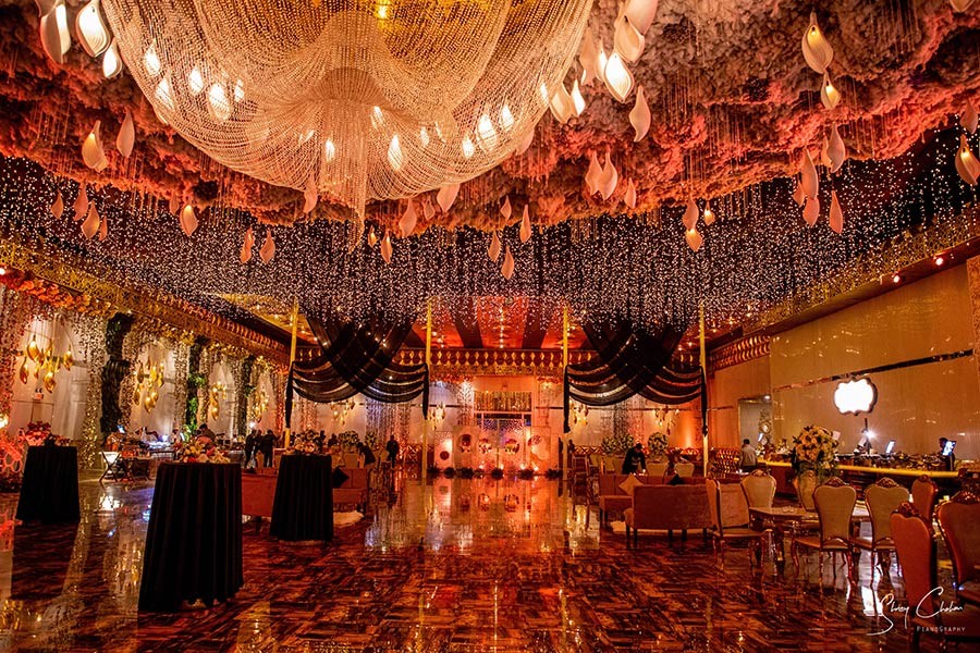 Warmly lit decorated venue at Vrinda and Mohit's wedding celebration