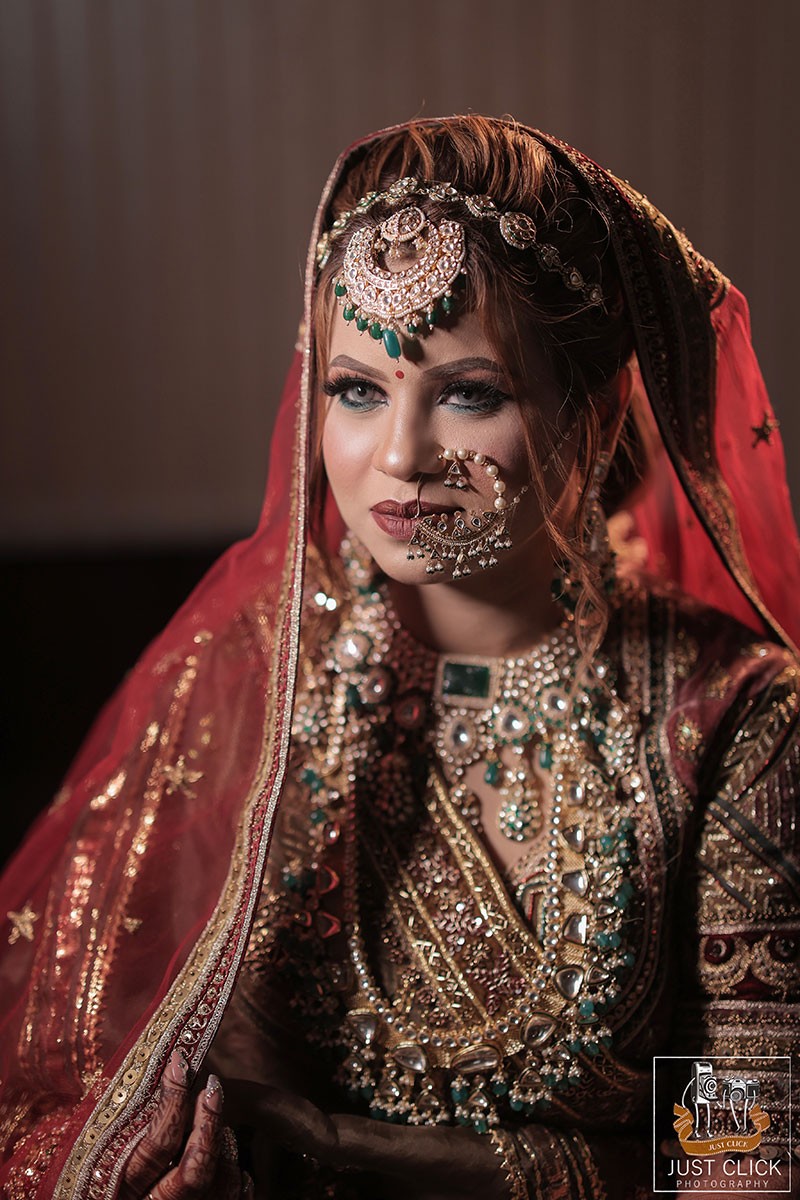 Close-up portrait of bride wearing a red veil