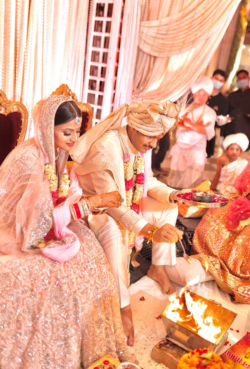 Wide view of the couple seated at the decorated mandap