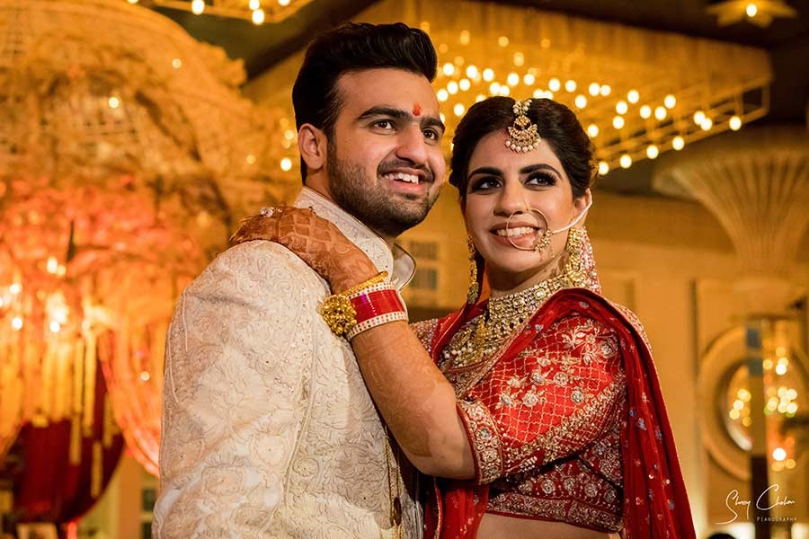 Bride and groom standing together during the garland exchange ceremony