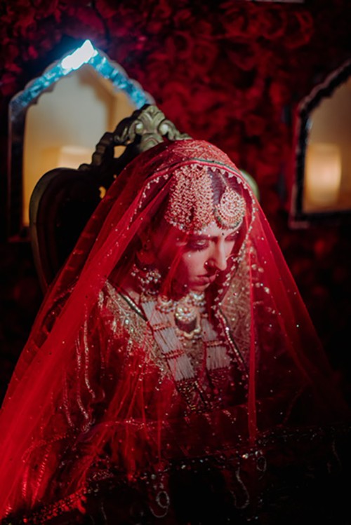 Close-up of an ornate red and gold bridal outfit