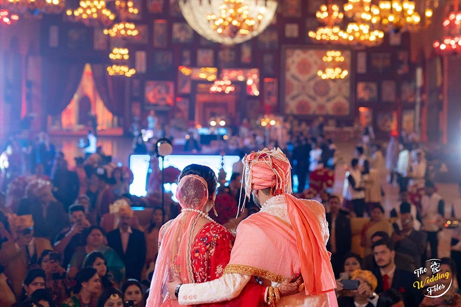 Sanya and Anish celebrating amid colorful festive lighting at their wedding