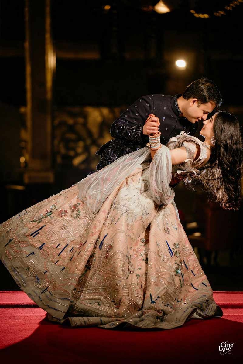 Bride showing the full length of her floral embellished gown
