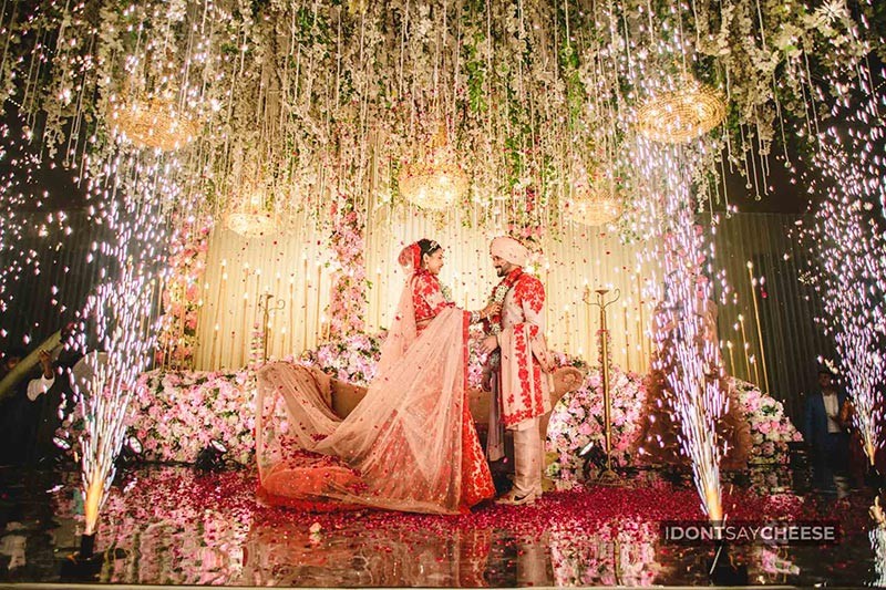 Bride and groom on stage with confetti falling around them