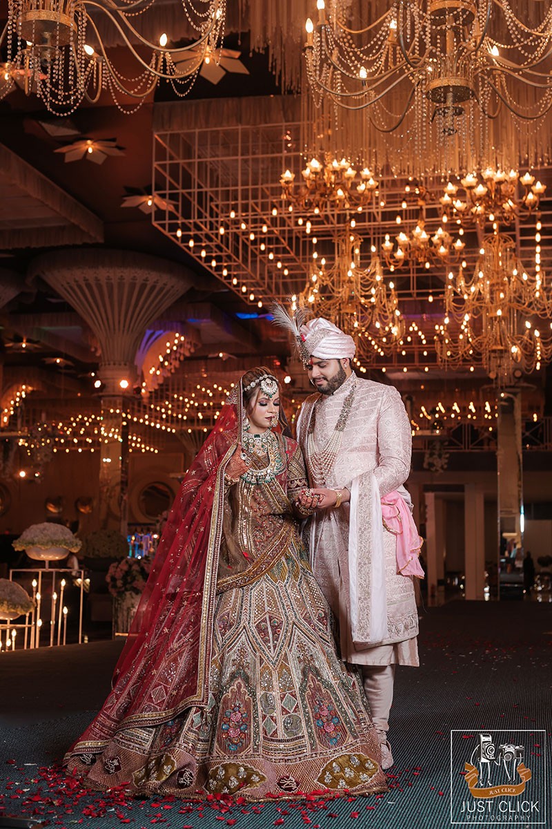 Bride and groom standing together on a decorated stage