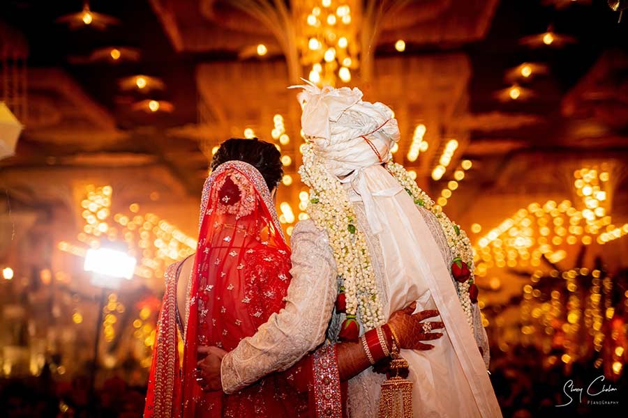 Bride and groom at the decorated mandap with floral backdrop