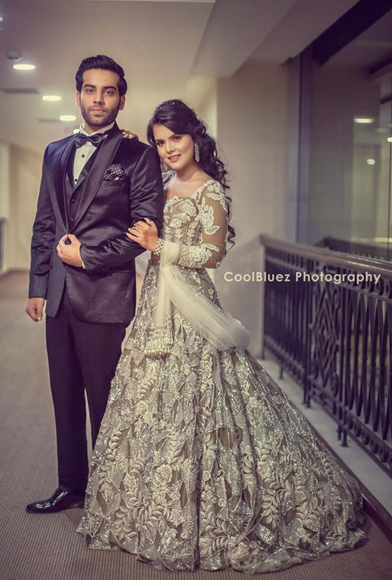 Neha and Pawan in formal wear at their wedding reception