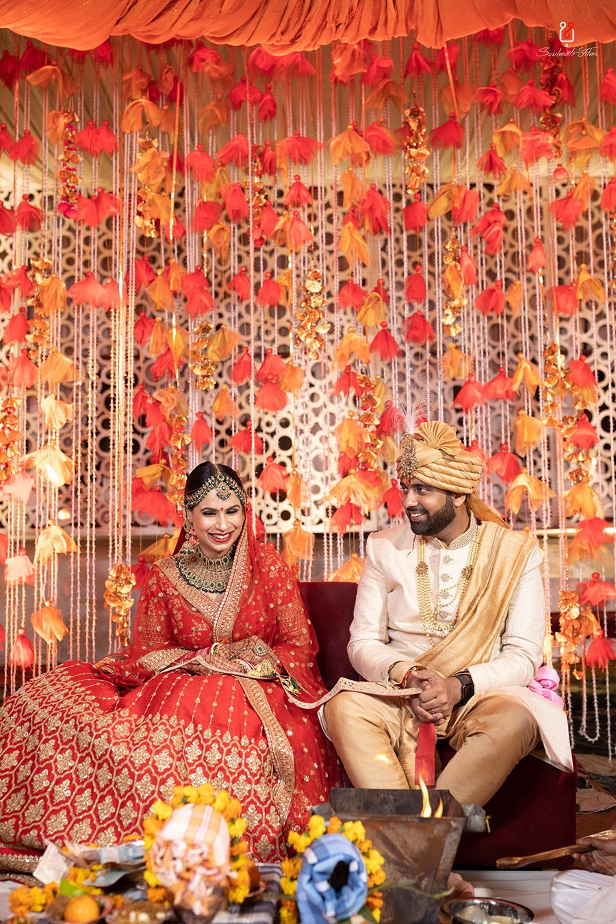 Ayushi and Shashwat amid red decor during their wedding celebration
